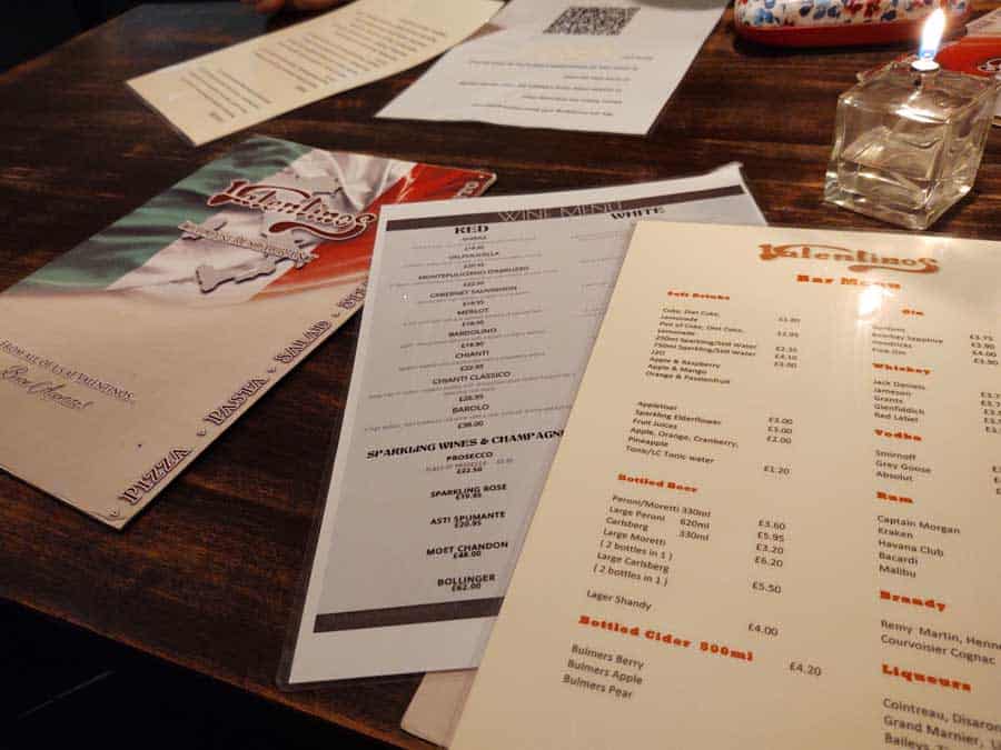 Various menus laid out on a table.